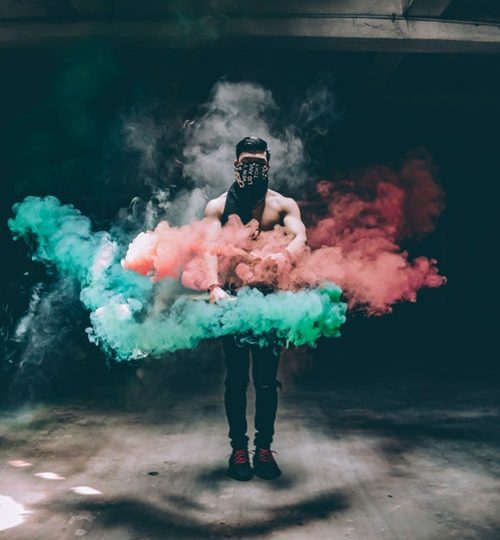 Man in colorful smoke.